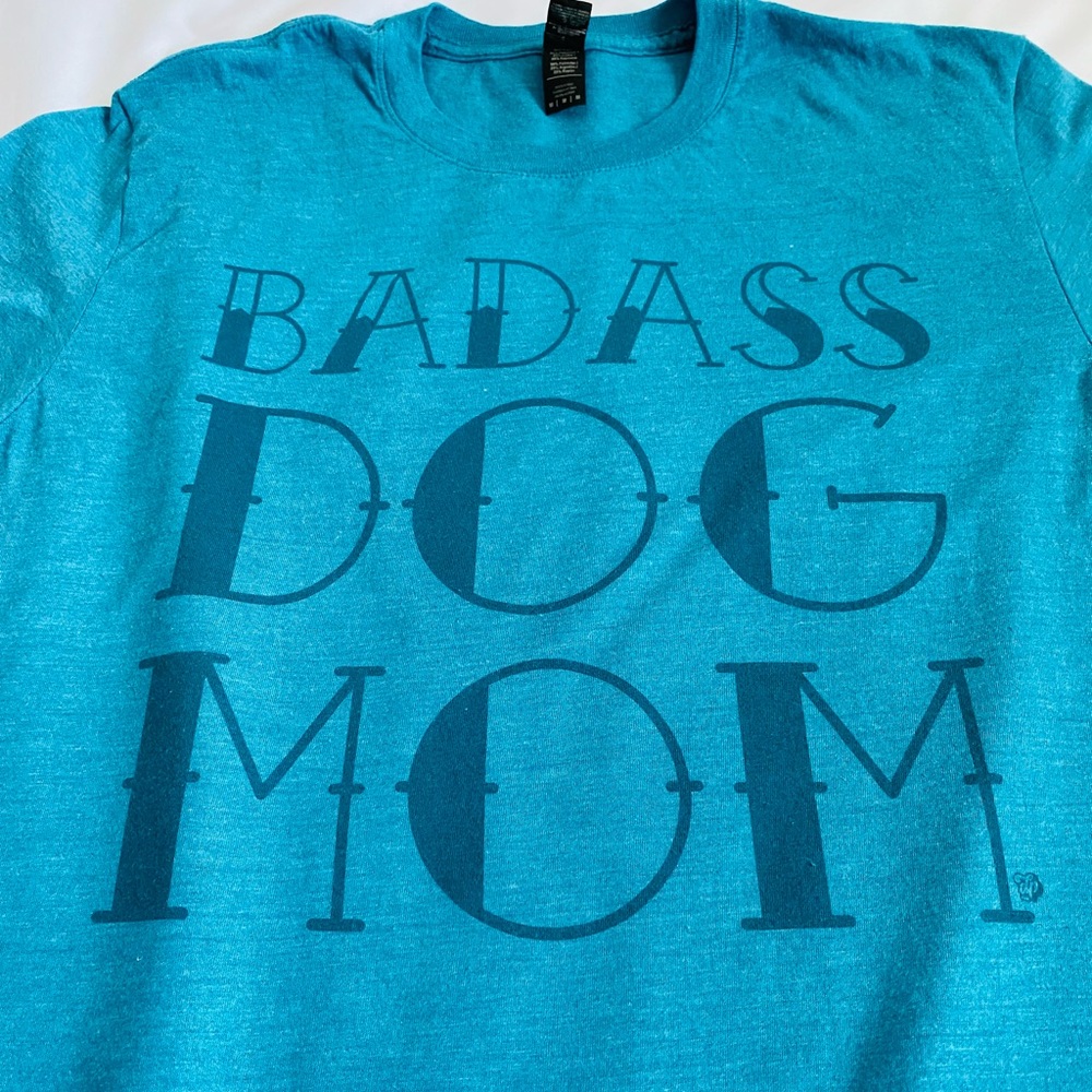 Women’s “Badass Dog Mom” Anvil Tri-Blend Shirt.  Color is Teal Blue. Med. EUC